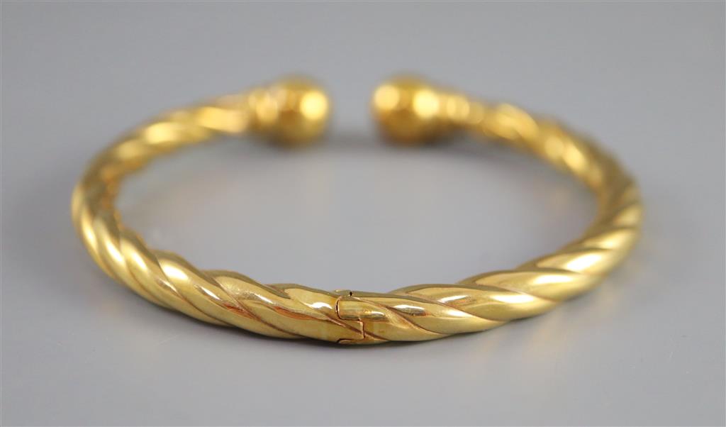 An Italian 18ct hollow gold twist sprung bangle,